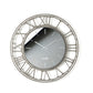 Vista frontale dell'orologio Axis 70 con numeri romani e quadrante in vetro specchio Crystal® fumé serigrafato. Base in ferro color fango. Diametro 70 cm. Prodotto da Arti&Mestieri.
